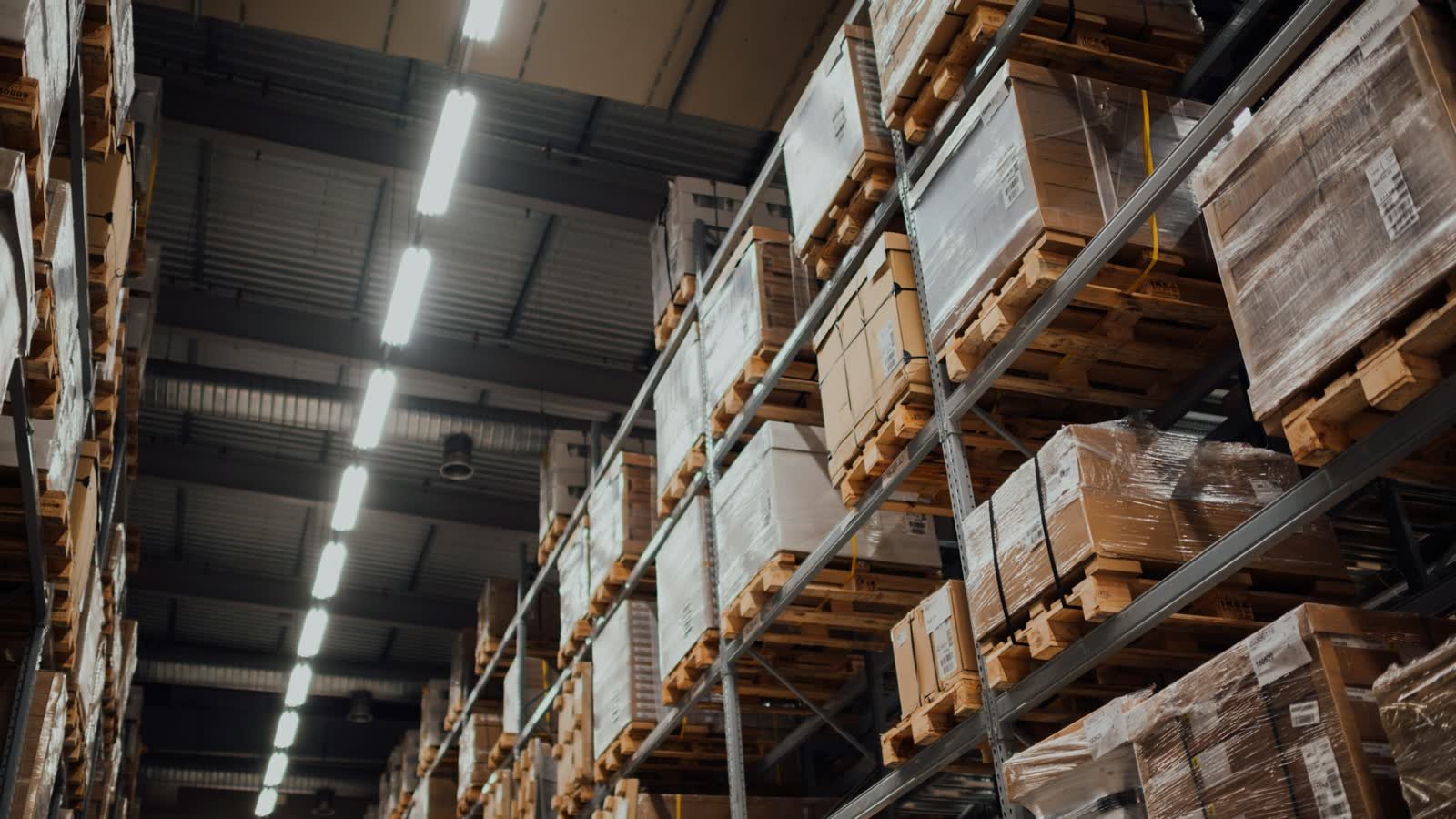Tall warehouse racking stacked with palletised stock